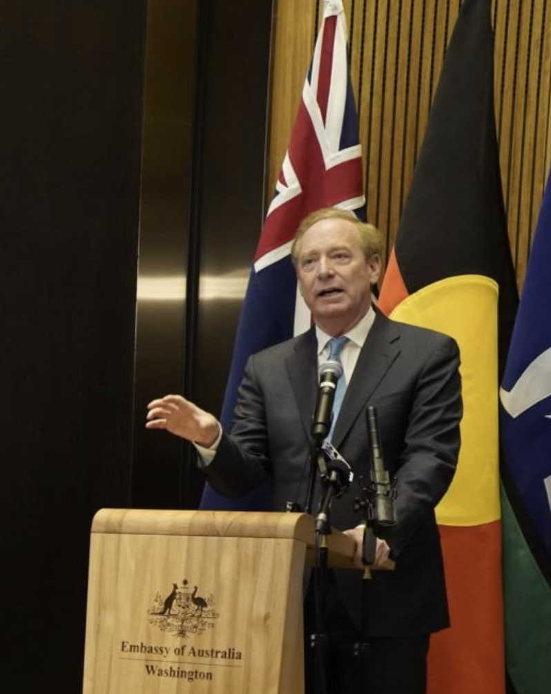 Brad Smith behind a podium speakng to the Embassy in Australia