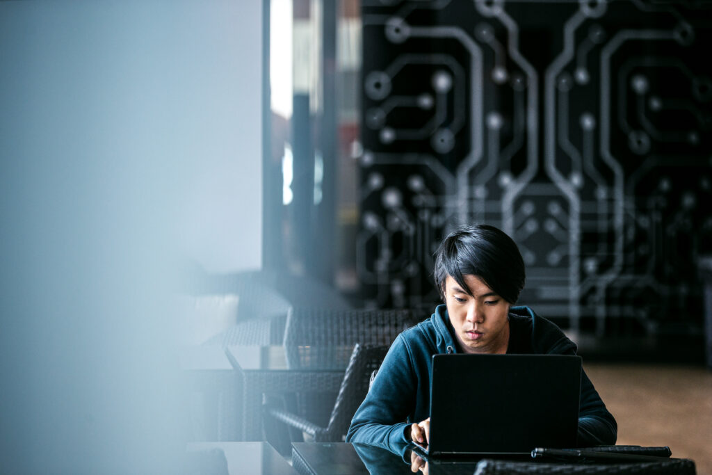 Young man working on a laptop in Singapore